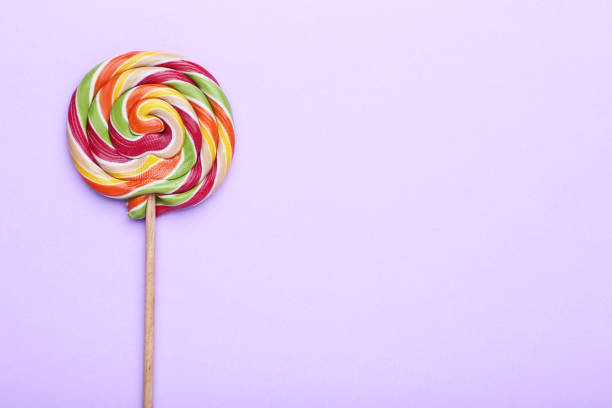 istock Colorful lollipop on purple background 1140521895