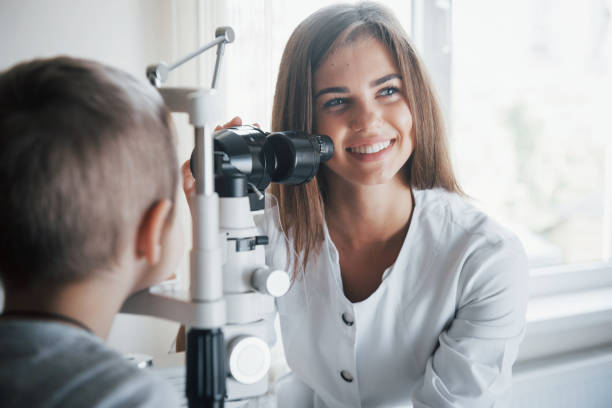 istock Checking little boy eyes with special apparatus and smiling 1140522024
