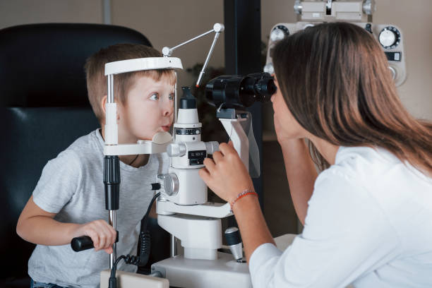 istock Making funny faces. Little boy having test for his eyes with special optical apparatus by female doctor 1140522066