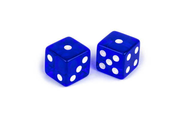 istock Two blue glass game dice very close up isolated on white background. Five and four with a shadow. 1140523886