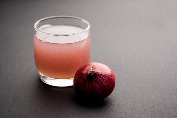 istock Medicinal Onion juice/syrup in a glass with raw onions. selective focus 1140524678