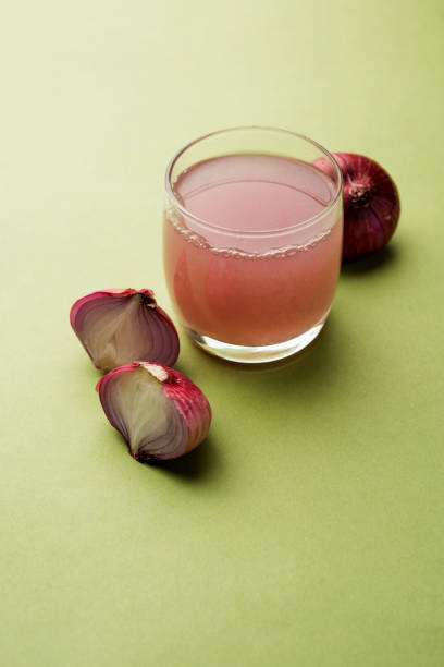 istock Medicinal Onion juice/syrup in a glass with raw onions. selective focus 1140524735