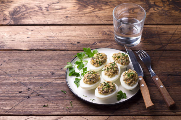 istock Stuffed eggs with mushrooms, cream cheese and parsley on a wooden table 1140524736