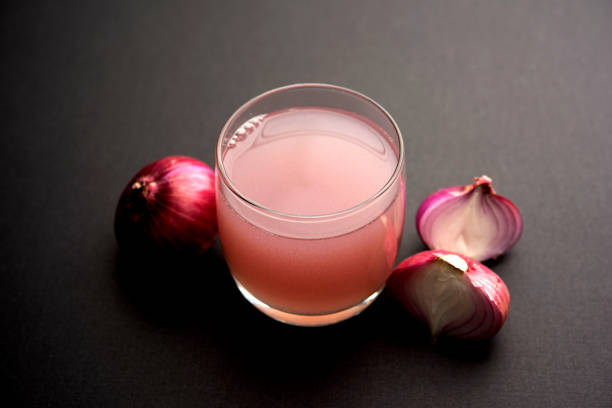 istock Medicinal Onion juice/syrup in a glass with raw onions. selective focus 1140524912