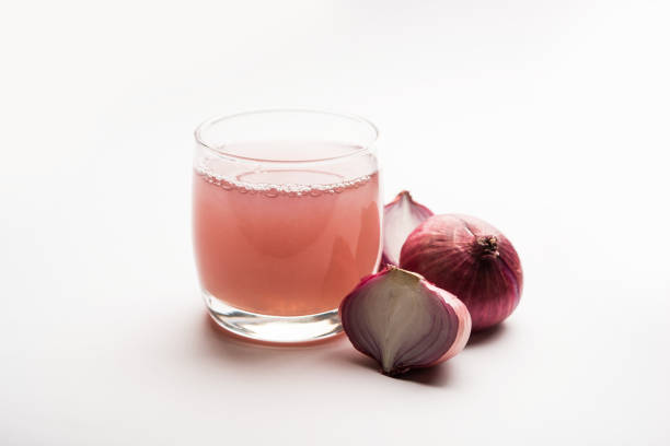 istock Medicinal Onion juice/syrup in a glass with raw onions. selective focus 1140524944
