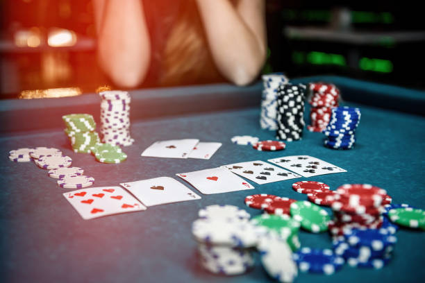 istock Poker chips and playing cards on table in casino 1140525075