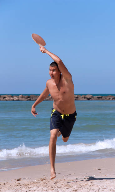 istock The guy playing tennis on the beach 1140525305