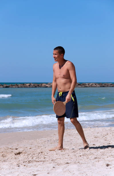 istock The guy playing tennis on the beach 1140525351