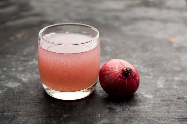 istock Medicinal Onion juice/syrup in a glass with raw onions. selective focus 1140525355