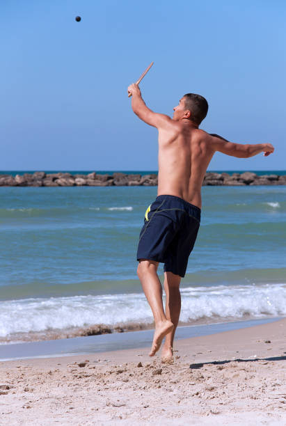 istock The guy playing tennis on the beach 1140525362