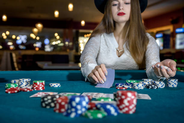 istock Female hand with playing cards and poker chips close up 1140525369