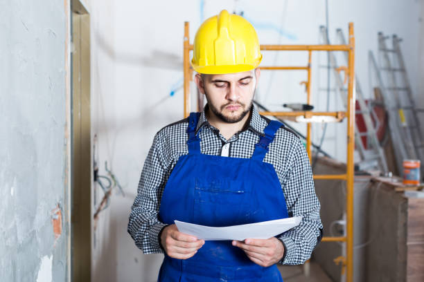 istock Plasterer is looking on the project of work for the object. 1140526530