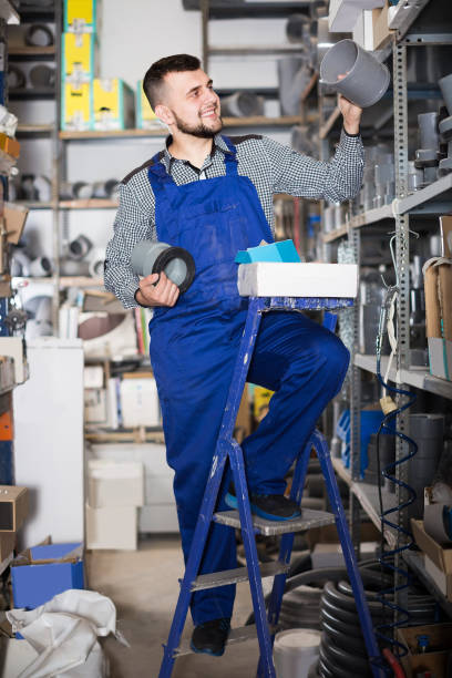 istock Charming worker in uniform with sanitary drain pipes 1140526663