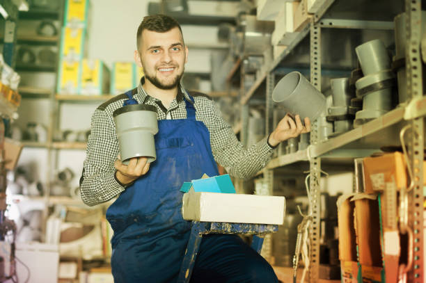istock Smiling male worker examining sanitary drain pipes 1140526672