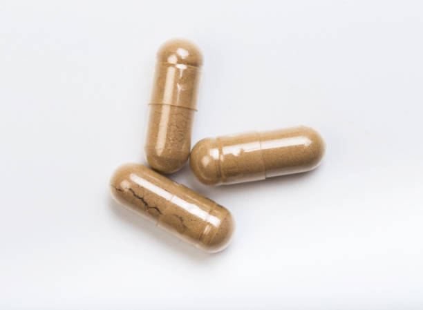 istock set of herbal  capsules on a white background - Image 1140527316