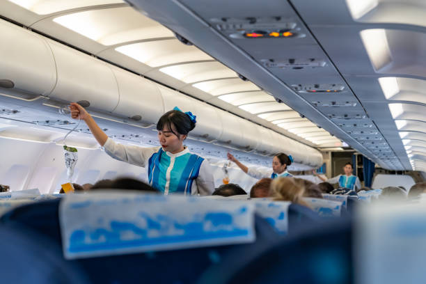 flight attendants demonstrate the proper use of oxygen masks before flight SUVANNABHUMI AIRPORT, BANGKOK, THAILAND - MARCH 23, 2019 : Flight attendants demonstrate the proper use of oxygen masks before flight oxygen mask plane stock pictures, royalty-free photos & images