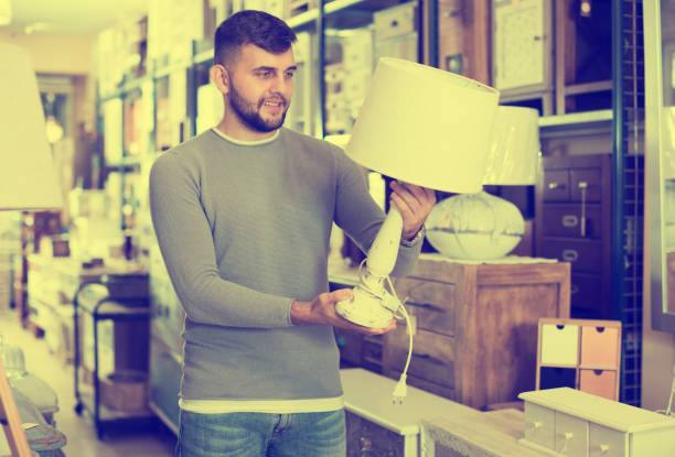 istock Happy man choosing vintage table lamp 1140527631