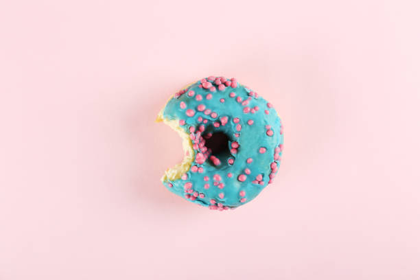 istock Minimal composition in vibrant colors with bright glaze donuts. 1140528590