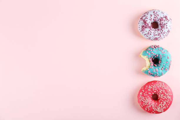 istock Minimal composition in vibrant colors with bright glaze donuts. 1140528593