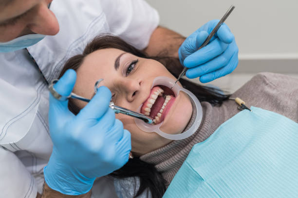 istock Dentist hands with instruments and patient face closeup 1140528795