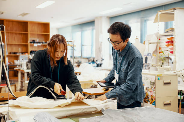 istock Two mid adult design professionals working together in a textile manufacturing studio 1140528805