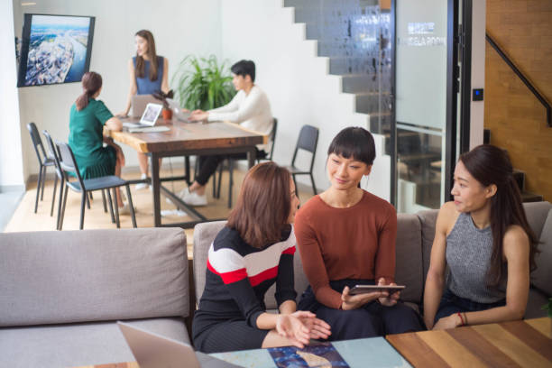 istock Young Asian Businesswomen Talking in Co-Working Space 1140531158