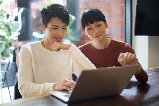 istock Young Asian People Using Laptop Together in Co-Working Space 1140531195