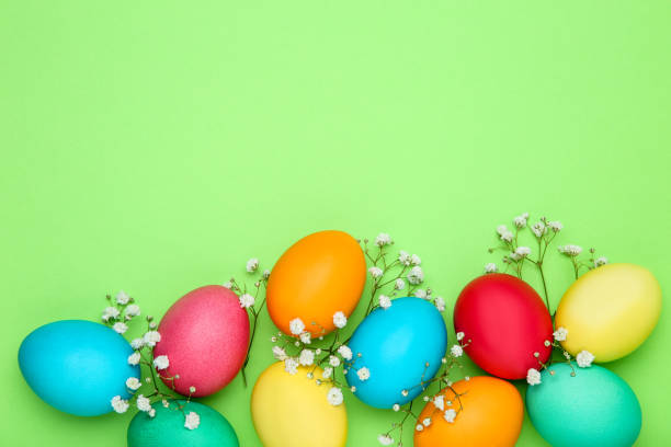 istock Colorful easter eggs with gypsophila flowers on green background 1140532039