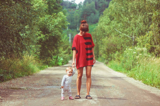 istock The child learns to walk on the grass 1140533752