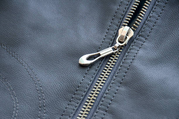 Close-up of zipper on leather texture. Horizontal background from a close-up of gray leather material