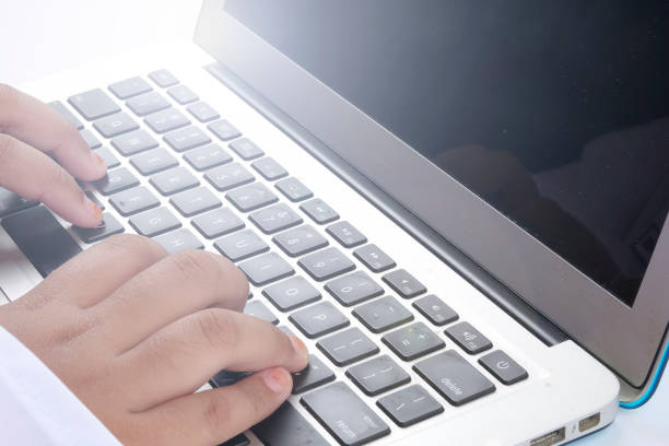 istock Cropped Hands Of Woman Using Laptop Against White Background 1140534971