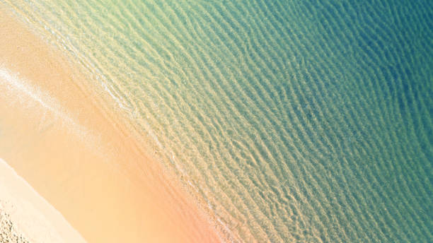 istock Beach with shade emerald blue water and wave foam on tropical sea 1140536735