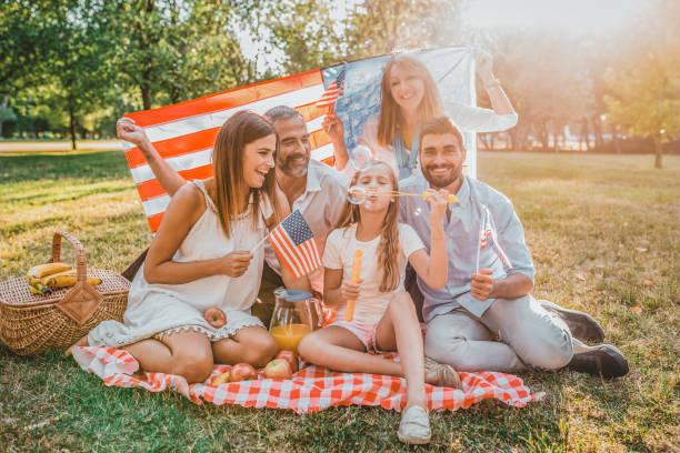 familia de tres generaciones en picnic en el parque - fourth of july family flag american flag fotografías e imágenes de stock