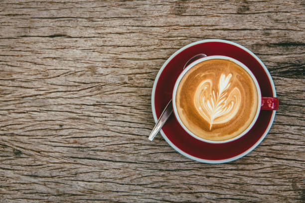 istock top view of hot coffee latte on wood table background. 1140543647