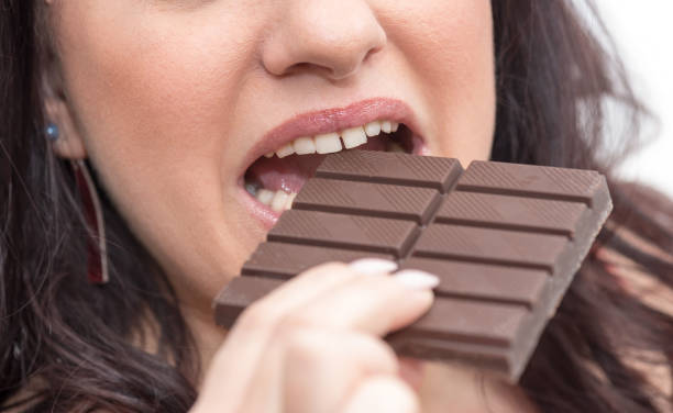 istock Woman biting in a chocolate bar 1140543650