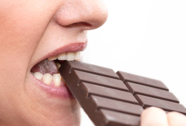 istock Woman biting in a chocolate bar 1140543655