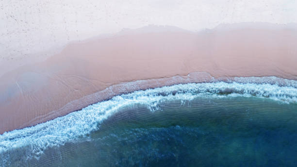 istock Beach with shade emerald blue water and wave foam on tropical sea 1140543858
