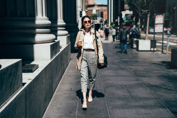 istock woman commuter walking drinking coffee 1140545524