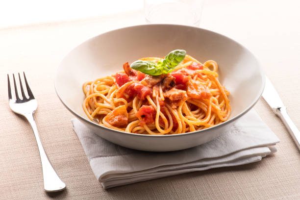 Spaghetti all' amatriciana from the Lazio region Spaghetti all' amatriciana from the Lazio region of Italy with pecorino cheese, pepper, tomato, cured pork jowl or guanciale served in a bowl as a first course to Italian cuisine all'amatriciana stock pictures, royalty-free photos & images