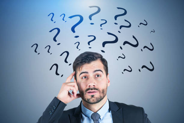 istock Confused businessman, blue question marks 1140550969