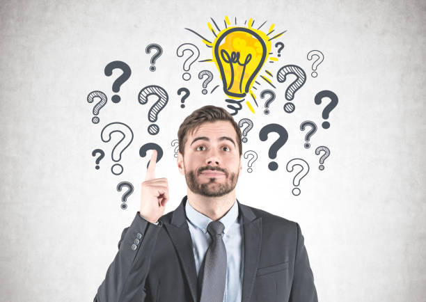 istock Businessman with idea, question marks and bulb 1140551146