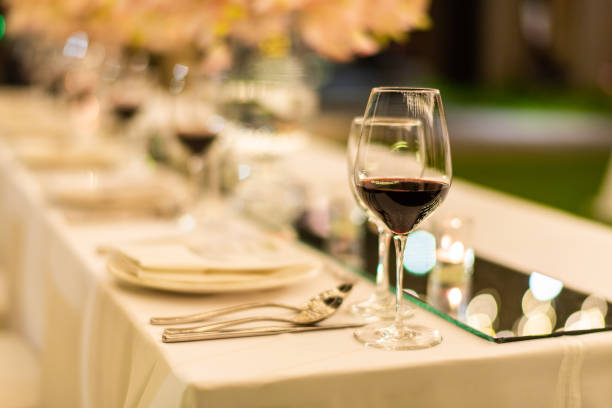 istock Beautiful wedding table setting decor with glasses of red wine. 1140551489