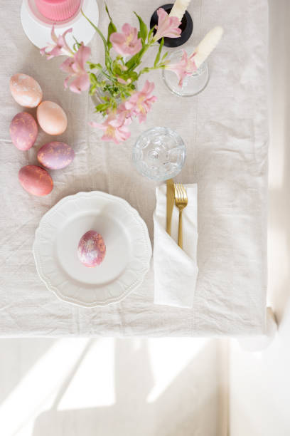 istock Beautiful festive Easter table setting with linen tablecloth, painted eggs and flowers 1140551638