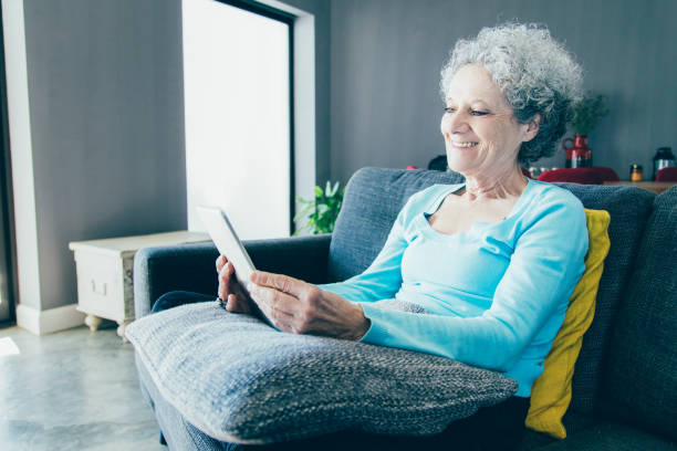 istock Happy positive elderly woman using tablet 1140552592