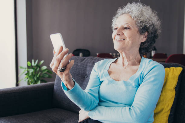 istock Positive retired woman using phone for video call 1140552603