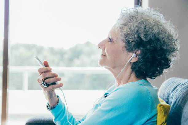 istock Serene senior smartphone user enjoying favorite music 1140552611