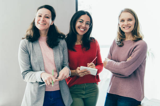 istock Smiling pretty female colleagues posing at camera 1140553476