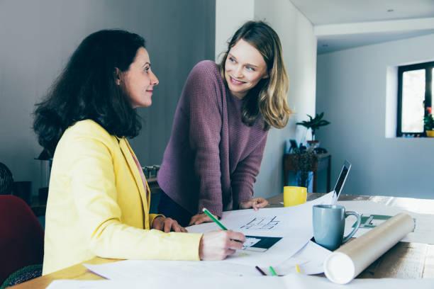 istock Architect discussing house design with smiling female client 1140553499