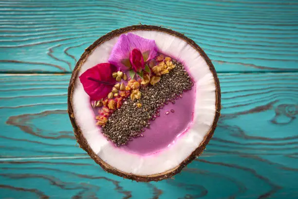 Acai bowl smoothie inside coconut chia granola blueberry and pitaya dragon fruit