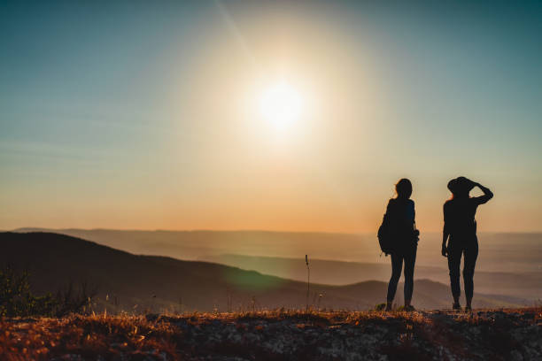 istock Two female hikers with backpacks at the mountain top 1140555279